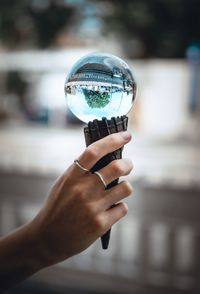 Close-up of hand holding ice cream cone with crystal ball