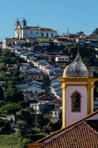 Buildings in city against clear sky