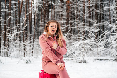 Portrait of woman standing in snow