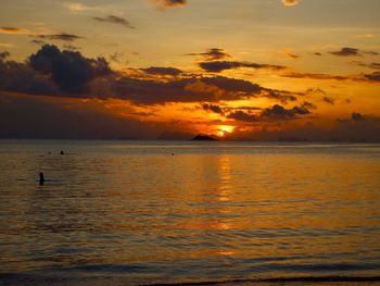 Scenic view of sea against orange sky