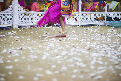 Low section of child playing with umbrella