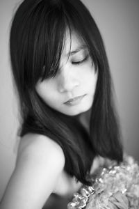 Close-up of young woman with bangs looking away