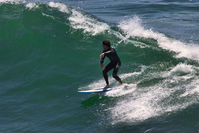 Full length of man surfing in sea