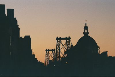 Silhouette of city against clear sky