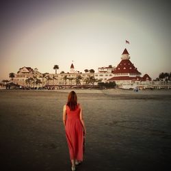 Woman standing by wall