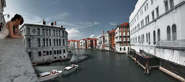 Boats in canal with buildings in background