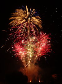 Low angle view of firework display at night