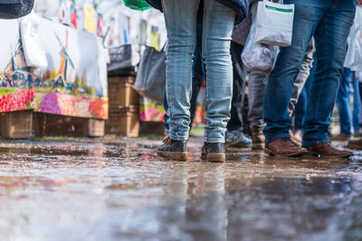 Low section of people walking on street