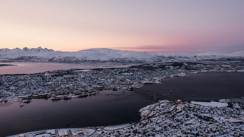 Scenic view of snowcapped mountains against sky during sunset