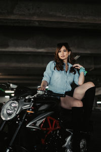 Portrait of woman sitting on motorcycle