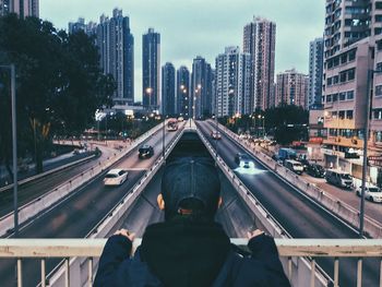 Train on railroad tracks in city against sky