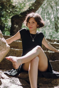 Portrait of young woman sitting outdoors