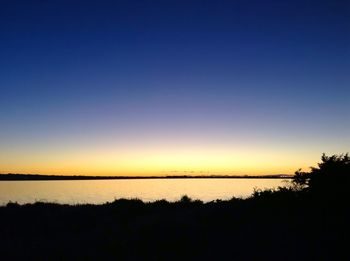 Scenic view of silhouette landscape against clear sky at sunset