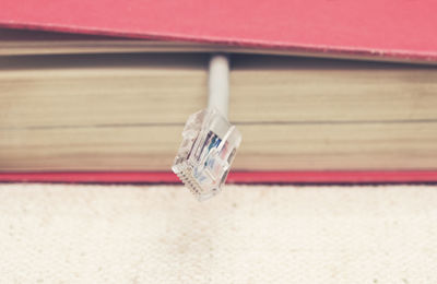 Close-up of modem cable in book on table