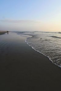 Scenic view of beach against sky during sunset