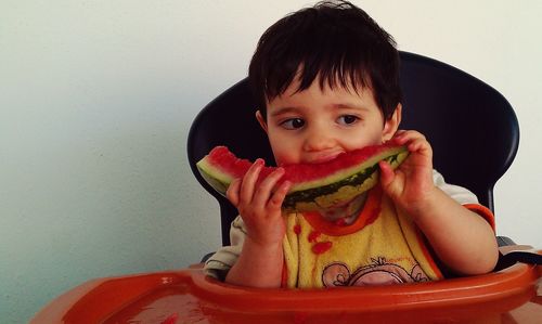 Portrait of cute boy eating