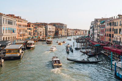 Boats, gondolas and water taxis navigating through grand canal in venice, italy.