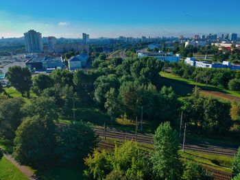 High angle view of trees and buildings in city