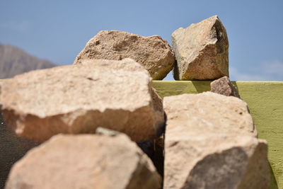 Close-up of rocks on rock against sky