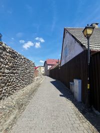 Street amidst buildings against sky