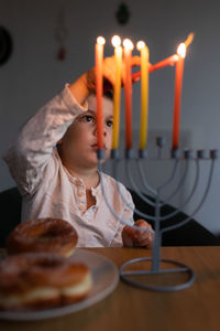 Portrait of young woman sitting on table