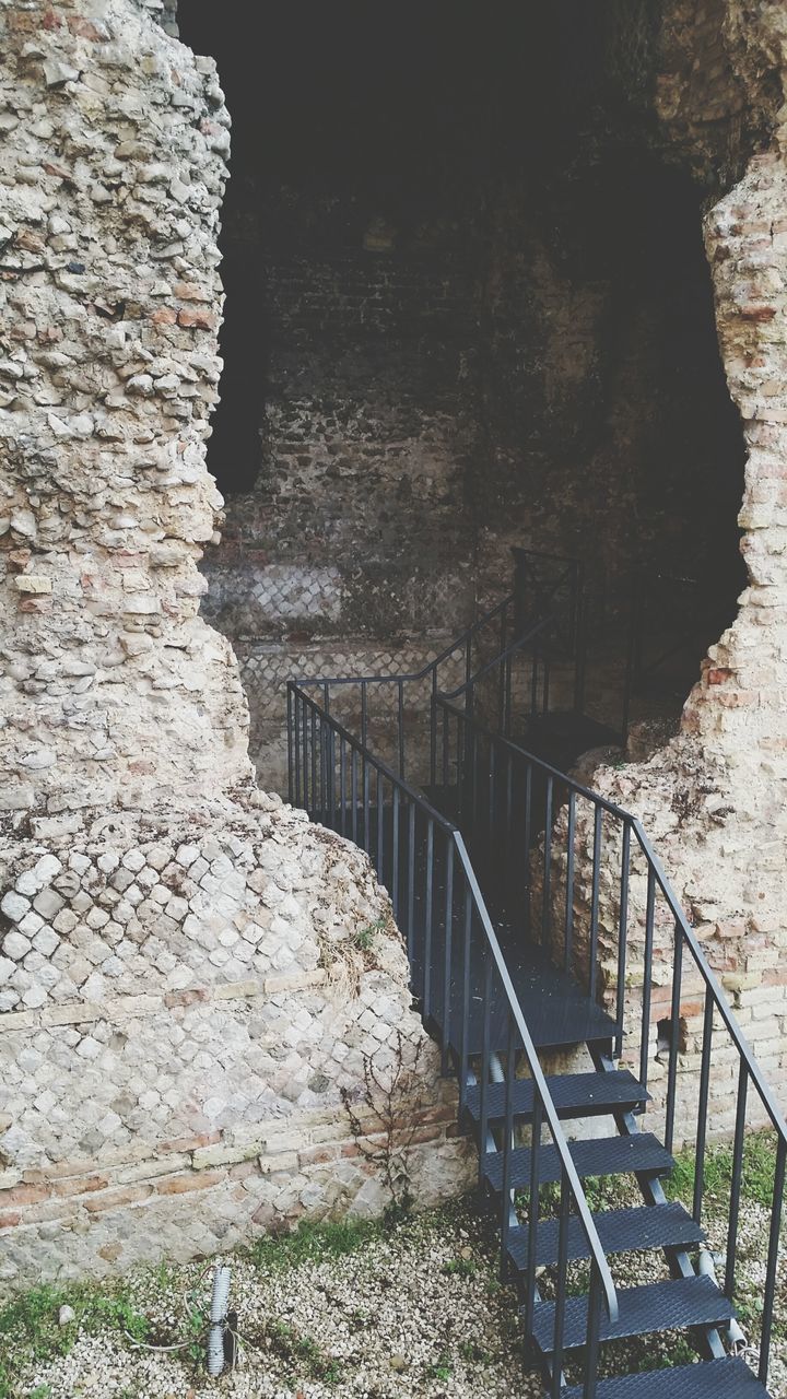 built structure, architecture, the way forward, railing, steps, rock - object, stone wall, water, wall - building feature, connection, bridge - man made structure, arch, steps and staircases, day, nature, tunnel, no people, outdoors, wall, narrow