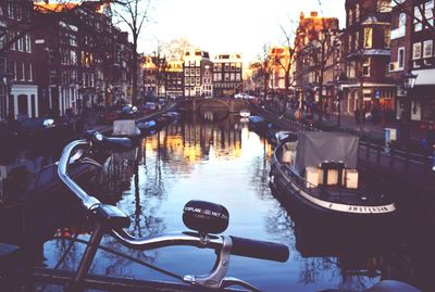 Boats in canal along buildings