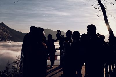 People against sky during sunset