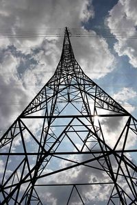 Low angle view of electricity pylon against sky