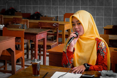 Portrait of woman sitting at table