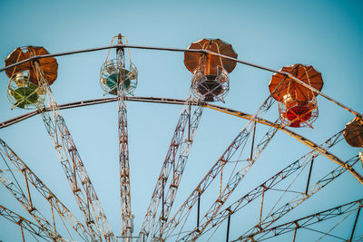 Low angle view of ferris wheel against clear sky