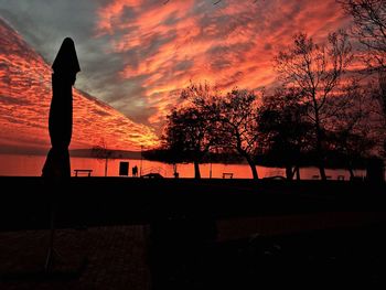 Silhouette trees against sky during sunset