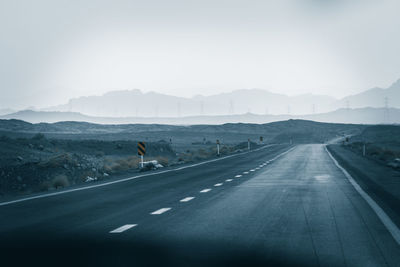 Road passing through mountains against sky