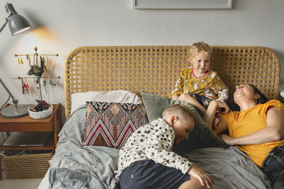 Rear view of women sitting on sofa at home