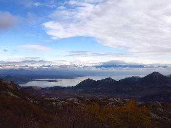 Scenic view of mountains against cloudy sky