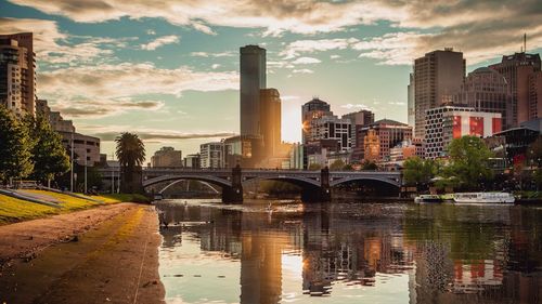 Bridge over cityscape against sky