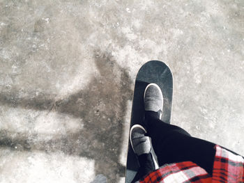 Low section of person skateboarding on street