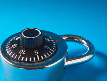 High angle view of clock on blue background