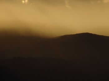 Scenic shot of silhouette mountains against sky at sunset