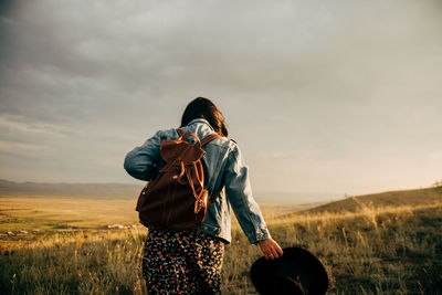 Rear view of man standing on field