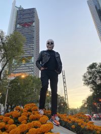 Full length of man standing against sky in city