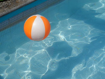 High angle view of ball floating on swimming pool