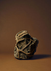 Close-up of stone against brown background