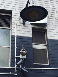 Low angle view of person against building