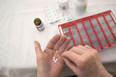 Close-up of person taking various medications