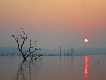 Scenic view of lake against sky during sunset