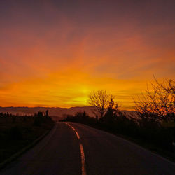 Diminishing perspective of road against romantic sky at sunset