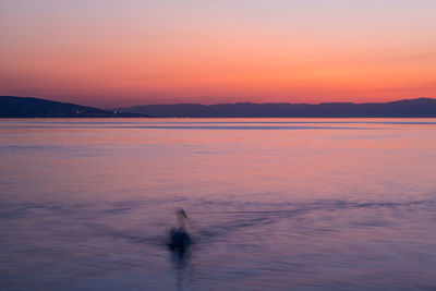 Scenic view of sea against sky at sunset