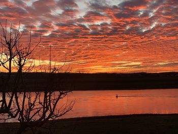Scenic view of lake against orange sky
