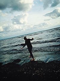 Silhouette of woman standing on beach